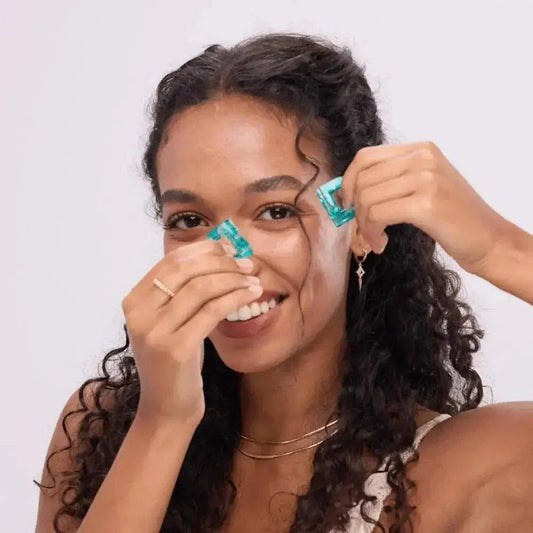Woman styling curly hair with turquoise hair clips, fashion accessories for everyday beauty