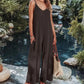 Woman in brown ribbed wide-leg jumpsuit by poolside, summer fashion outfit with straw bag