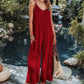 Woman in red pleated jumpsuit by poolside, summer fashion outfit with wide legs and V-neck