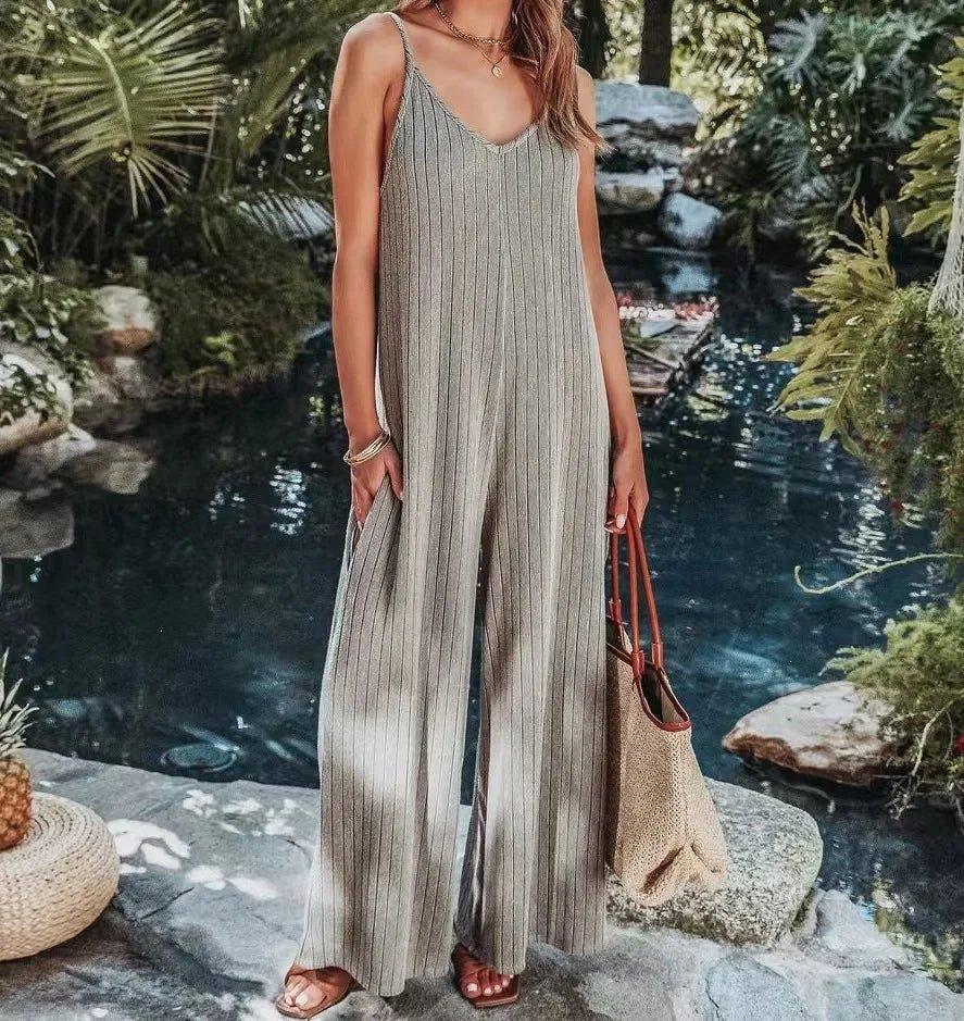 Woman in striped wide-leg jumpsuit by poolside, summer fashion outfit with woven bag