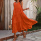Orange tiered maxi dress for women, summer boho style with straw hat and woven bag