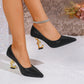 Sparkly black pointed-toe heels with gold music note heels and rhinestone ankle strap, perfect for women's fashion events.