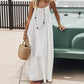Woman in white boho maxi dress with straw bag, standing by vintage car, summer fashion style