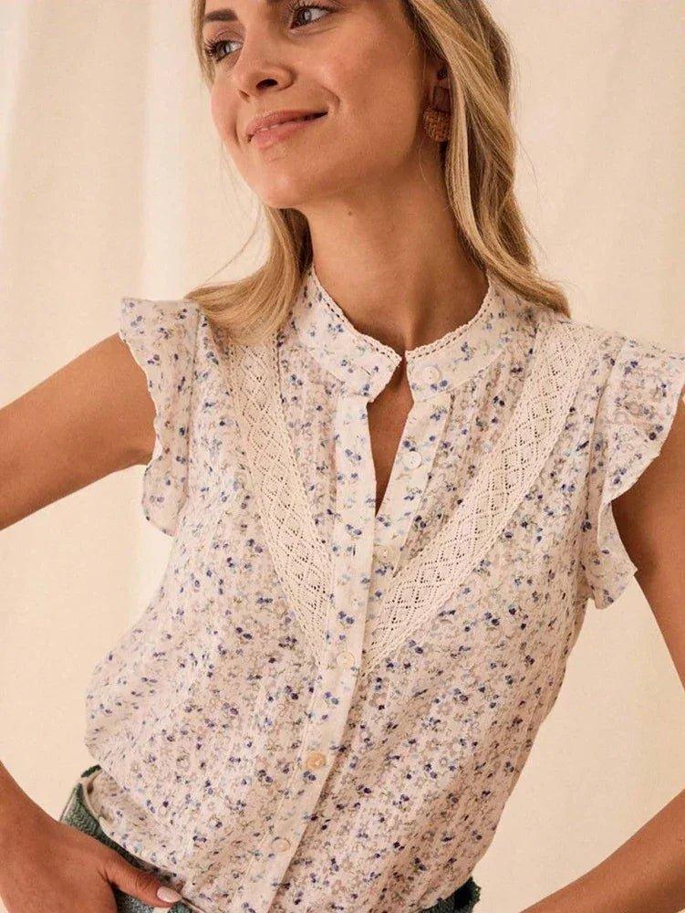 Woman wearing floral print blouse with lace trim and ruffle sleeves, stylish summer fashion top