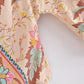 Floral print women's fashion top with vibrant botanical pattern and decorative trim