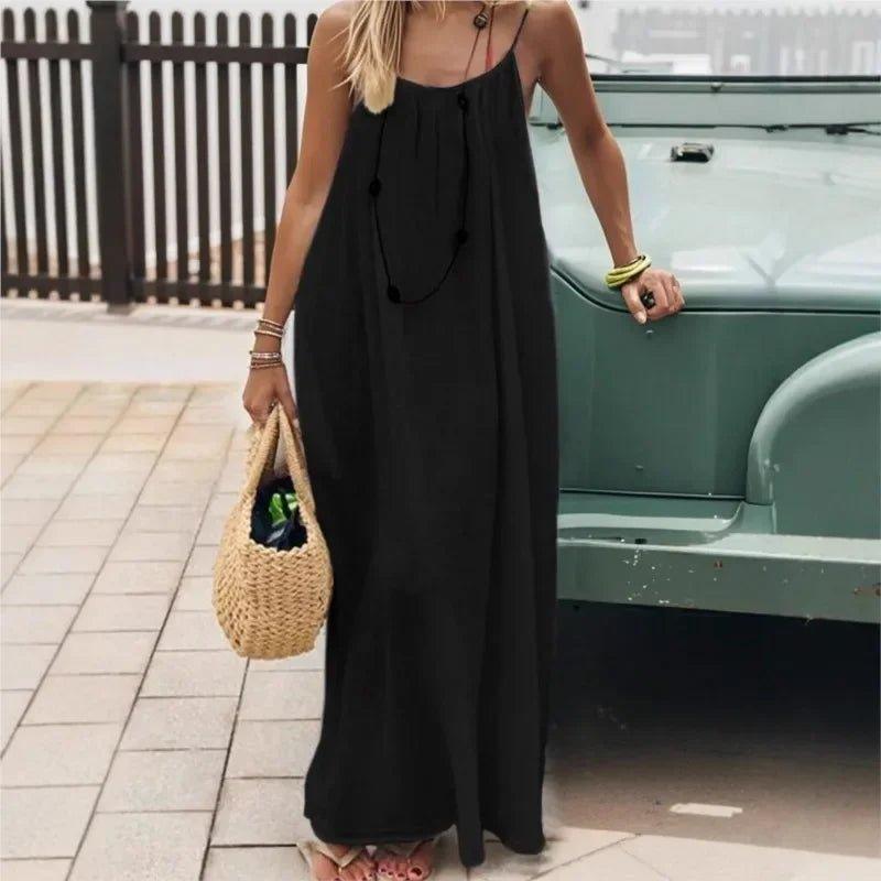 Woman in black maxi dress with straw bag, summer fashion outfit