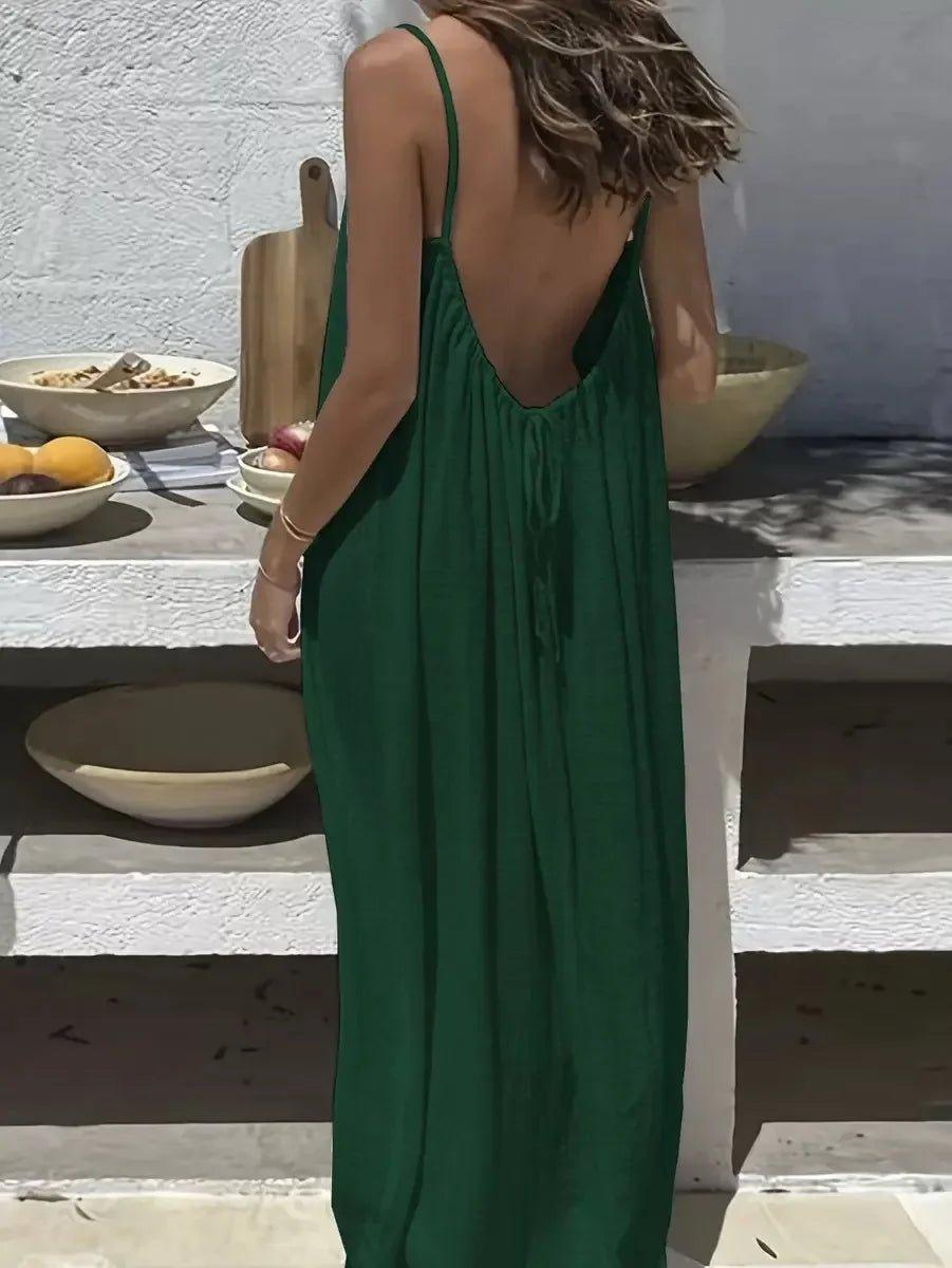 Woman in green backless maxi dress, summer fashion, beach style, flowy silhouette