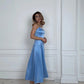 Woman in elegant light blue satin strapless midi dress, perfect for evening events and fashion occasions