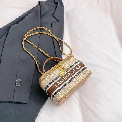 Stylish women's fashion handbag with gold chain strap and 'FASHION&BAG' print, paired with gray blazer