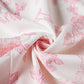 White fabric with pink floral print, soft texture for women's fashion clothing