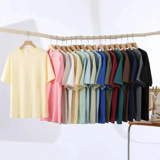 Women's fashion t-shirts in assorted colors hanging on wooden hangers for casual wear