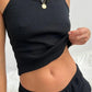 Black ribbed crop top with twisted hem, paired with matching shorts, stylish women's fashion set