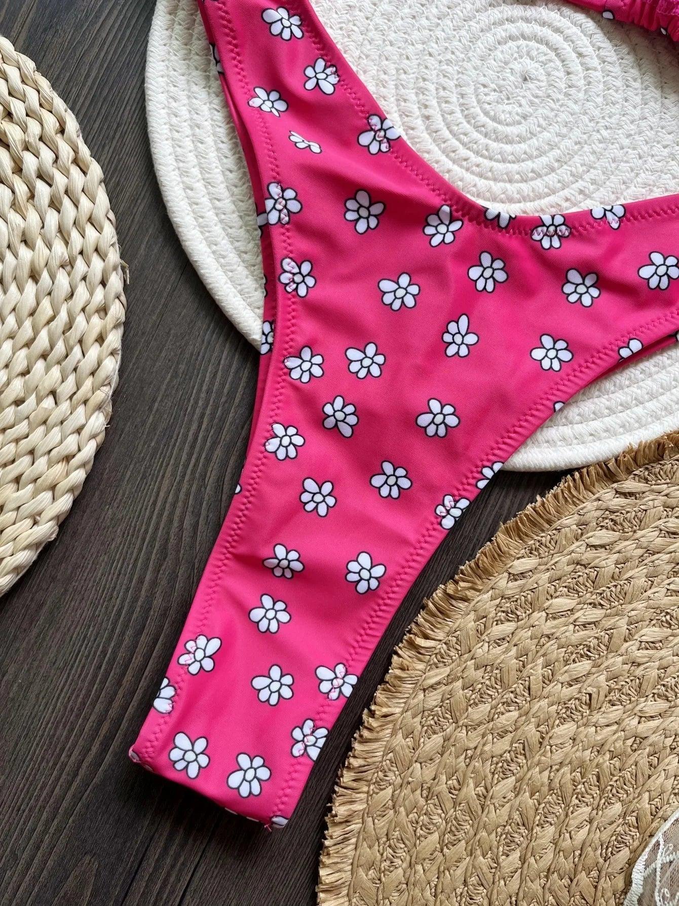Pink floral bikini bottom with white daisies on woven straw hats, beach fashion