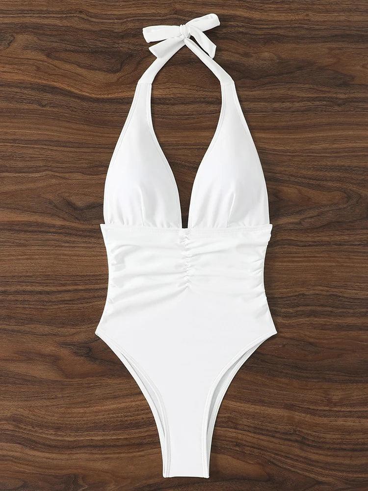 White halter neck one-piece swimsuit with ruched waist, perfect for beach fashion