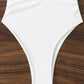 White one-piece swimsuit with ruched front, high-cut legs, laid on wood surface