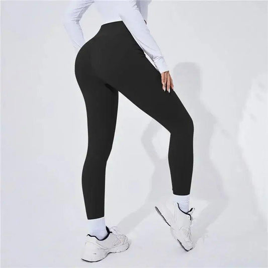 Black high-waist leggings for women, perfect for gym, yoga, or casual wear with white sneakers.