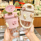 Cute pink and white quilted water bottles with pearl straps, bunny charms, and bow details for women's fashion
