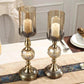 Elegant brass candle holders with glass shades, perfect for home decor and romantic table settings