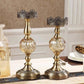 Elegant brass candle holders with crystal bases and ornate crowns, perfect for luxury home decor