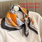Elegant women's silk scarf with orange, blue, and black geometric print, styled on a cream blazer for fashion accessory look
