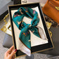 Luxury teal silk scarf with horse print, styled in gift box for women's fashion accessories