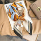Elegant horse print silk scarf with orange blue stripes, styled with beige blazer, sunglasses, and handbag for women's fashion