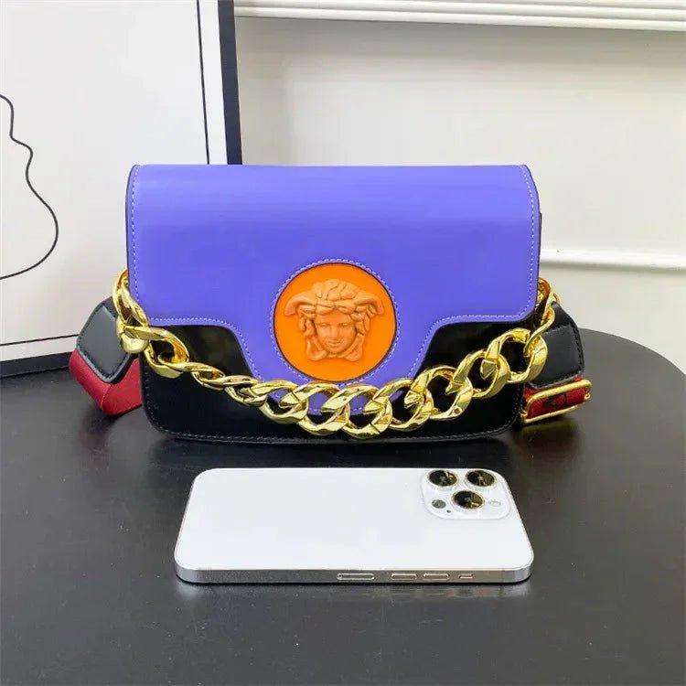 Purple and black designer handbag with gold chain strap and Medusa emblem, luxury women's fashion accessory