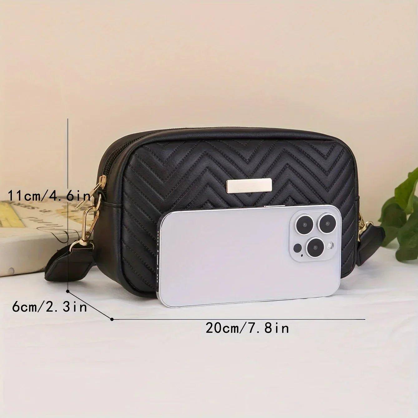 Black quilted crossbody bag with gold hardware, shown with phone for scale, perfect for women's fashion
