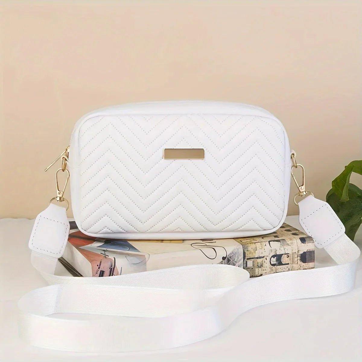 White quilted crossbody bag with chevron pattern and gold hardware, stylish women's fashion accessory