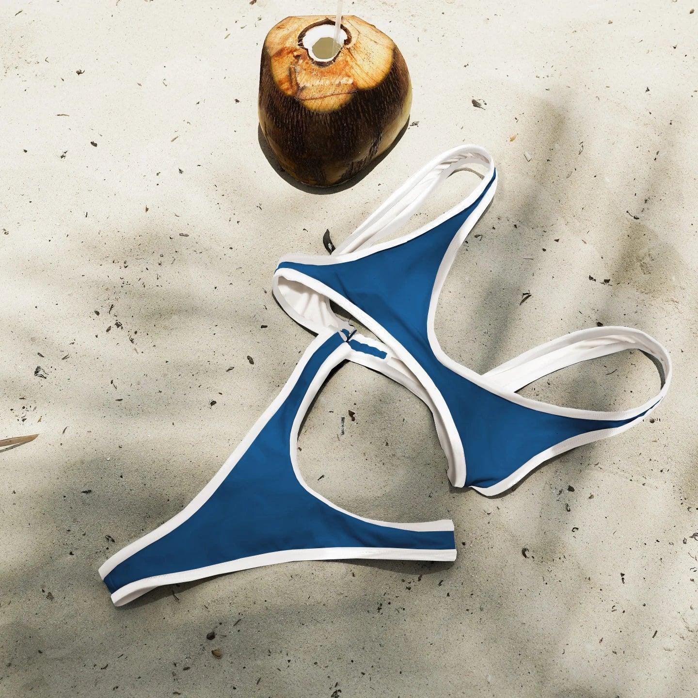 Blue and white bikini set on sandy beach with coconut drink, perfect for summer fashion