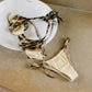 Tie-dye bikini set with metallic straps, styled on white plate for women's fashion