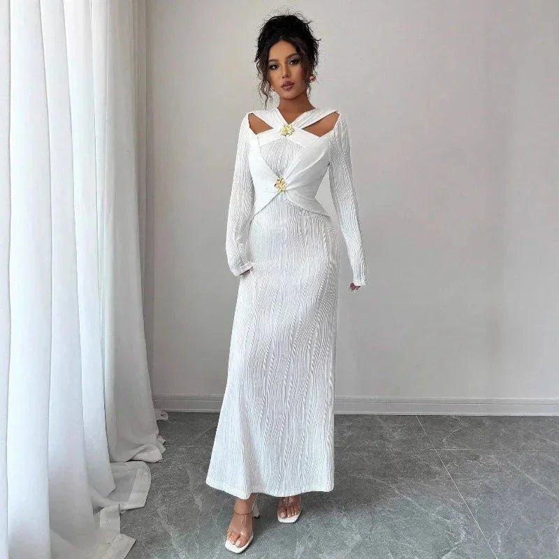 Elegant white long-sleeve maxi dress with cutout shoulders and gold accents, perfect for women's fashion events.