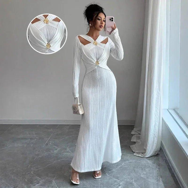 Elegant white long-sleeve maxi dress with cutout shoulders and gold embellishments, perfect for women's fashion events.
