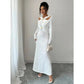 Elegant white long-sleeve maxi dress with cutout shoulders and gold accents, perfect for women's fashion events.