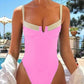 Pink one-piece swimsuit with cutout detail, poolside fashion for women