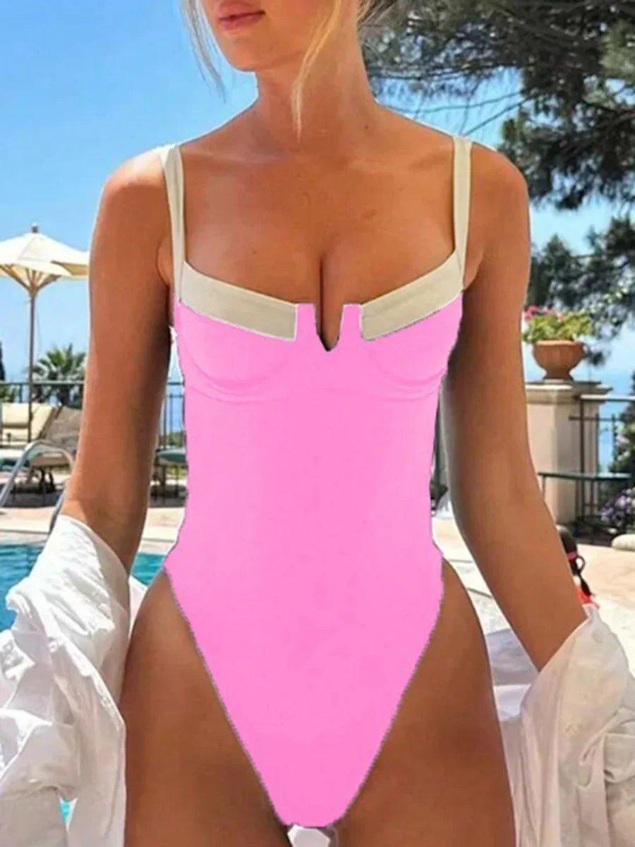 Pink one-piece swimsuit with cutout detail, poolside fashion for women