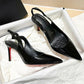 Black patent leather stiletto heels with red soles, pointed toe slingback design for women's fashion