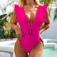 Bright pink one-piece swimsuit with ruffle shoulders and belt buckle, poolside fashion