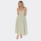Woman in elegant sage green midi dress with square neckline and white heels, perfect for women's fashion