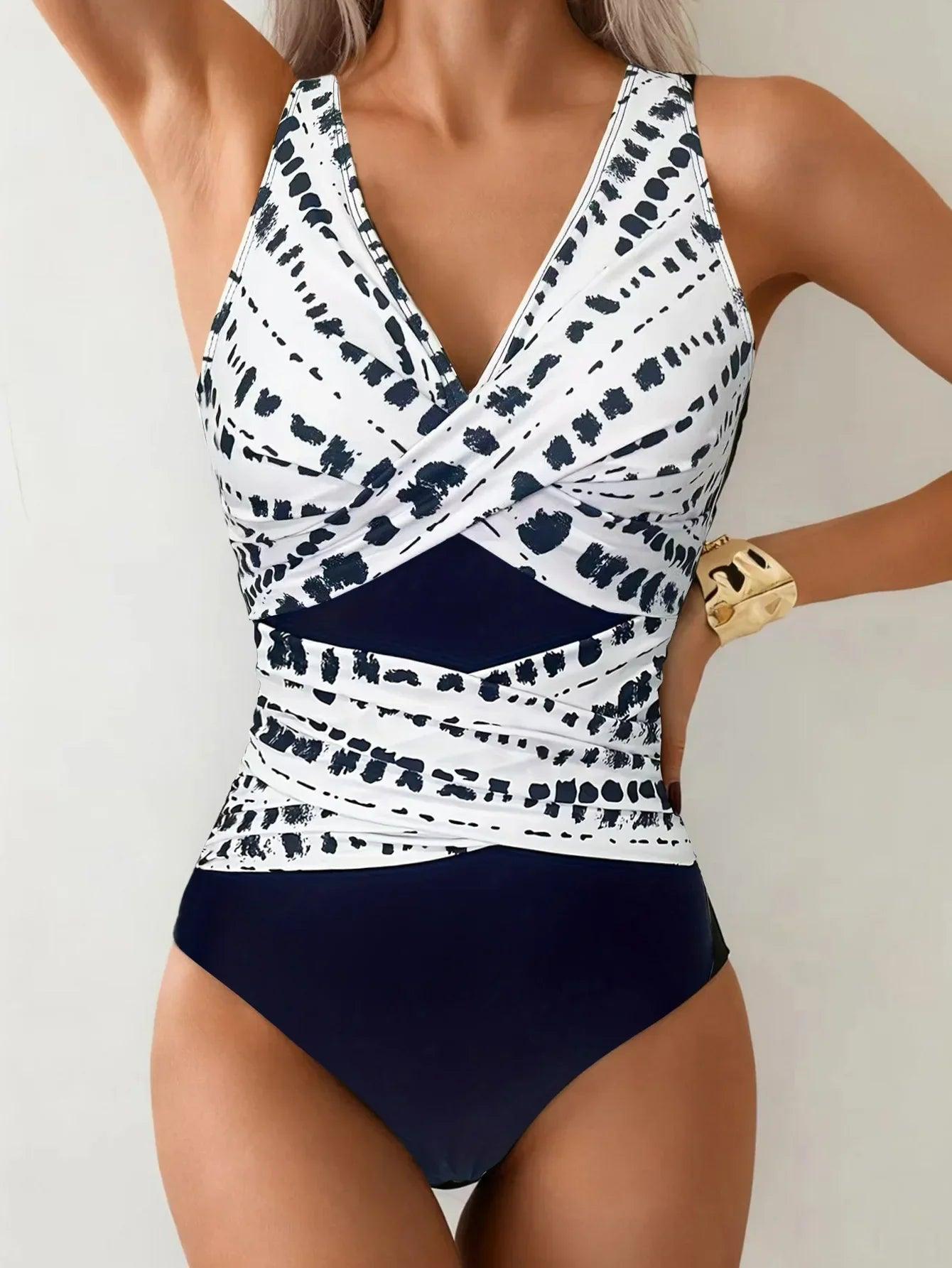 Women's navy and white patterned one-piece swimsuit with V-neck and wrap design
