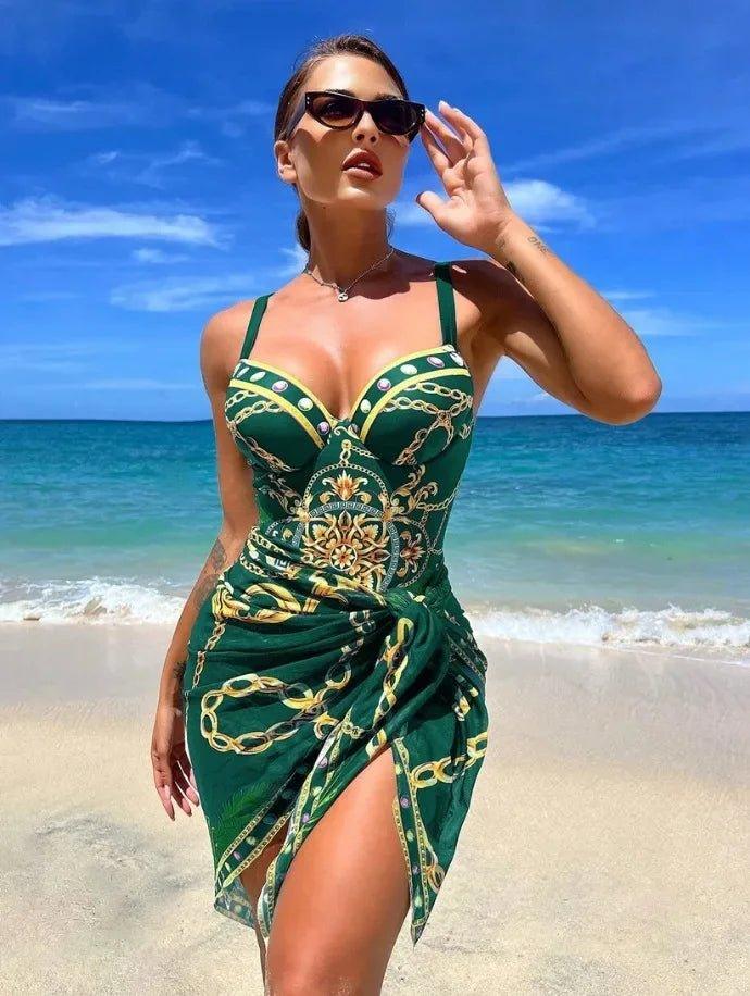 Woman in green chain-print beach dress with high slit, sunglasses, ocean backdrop — summer fashion