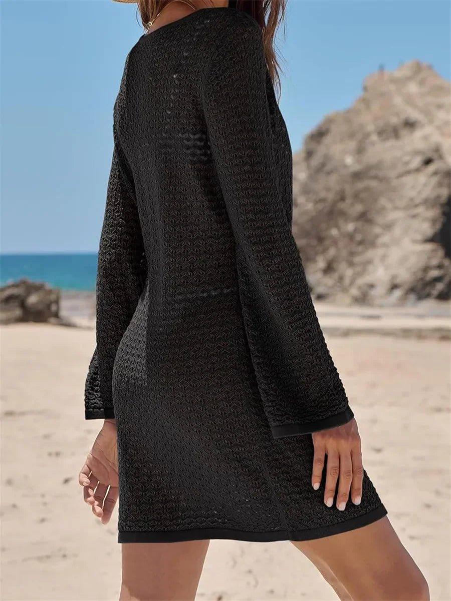 Black textured long-sleeve beach dress with flared sleeves, perfect for summer fashion