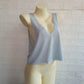 Light gray women's V-neck crop tank top on mannequin, casual fashion wear