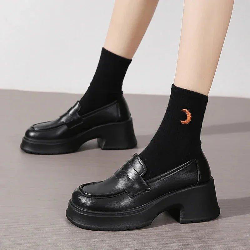Black platform loafers with chunky heels paired with moon-embroidered socks, women's fashion footwear