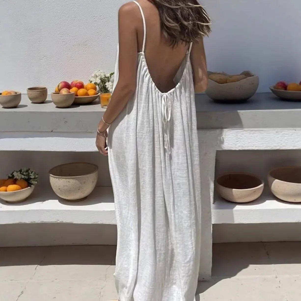 White backless maxi dress for women, summer beach fashion with fruit bowls on shelves