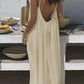 Cream backless maxi dress with thin straps, perfect for summer fashion and beach style