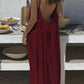 Woman in red backless maxi dress, summer fashion, beach style, boho chic, outdoor setting