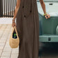 Woman in olive green maxi dress with straw bag, summer fashion outfit