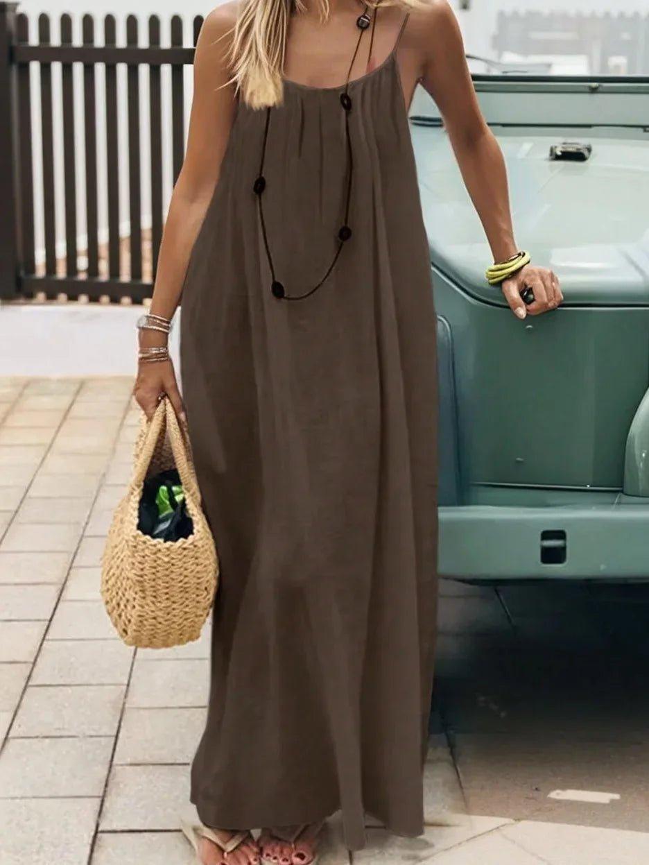Woman in olive green maxi dress with straw bag, summer fashion outfit